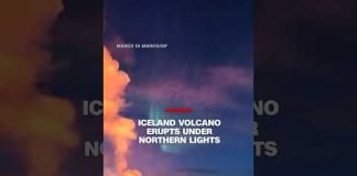 Iceland volcano erupts under northern lights