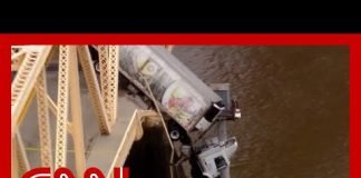 Truck dangles off bridge after crash. See the 'harrowing' rescue of driver