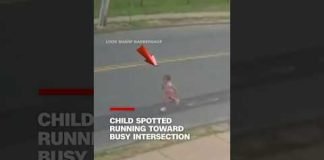 Child spotted running toward busy intersection