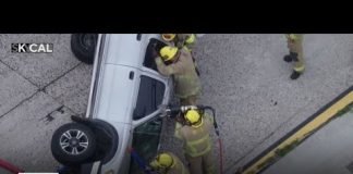 Firefighters rescue driver from overturned truck on 405 Freeway