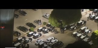 Police arrive to UCLA in force as hundreds of protesters remain in encampment