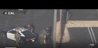 Police lead people out of the Anaheim bank after responding to an attempted bank robbery
