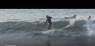 Surfers head to the beach in spite of ocean water advisory