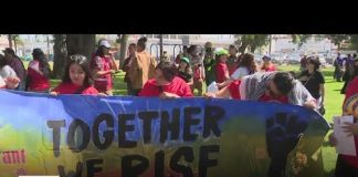 Workers and activists hold a May Day rally in Fontana