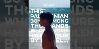 Palestinian boy with amputated limbs plays on Gaza Beach