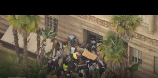 Protesters barricade near Moore Hall on UCLA campus as police surround area